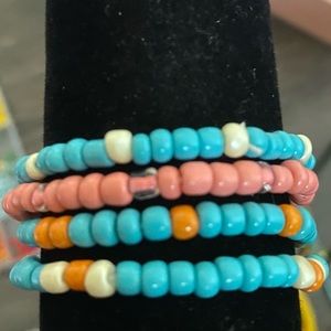 Bracelet set of four, orange and turquoise themed.